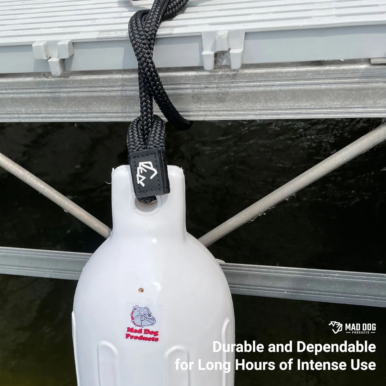 Marine-A-Content-Fender-Line White boat fender hanging from a dock with black rope.