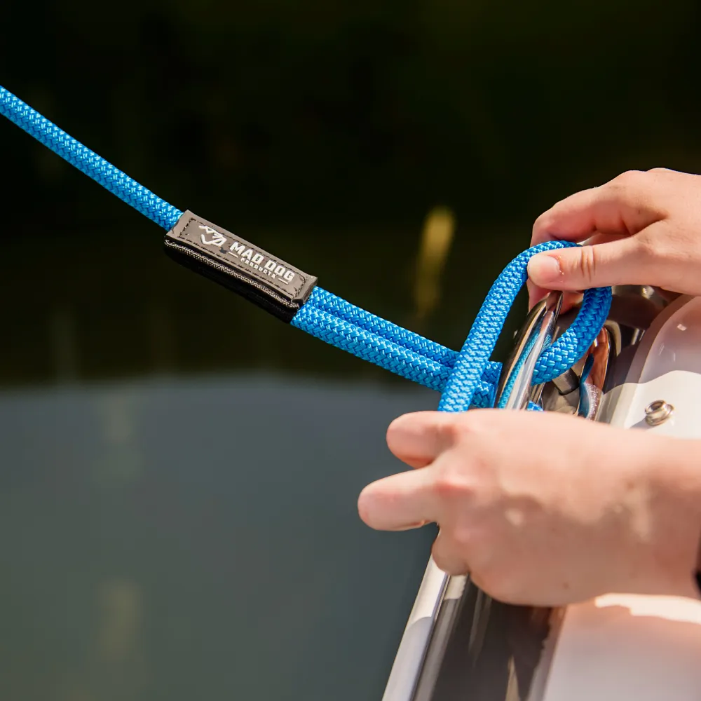 Blue nylon dock line secured to boat cleat for boating safety.