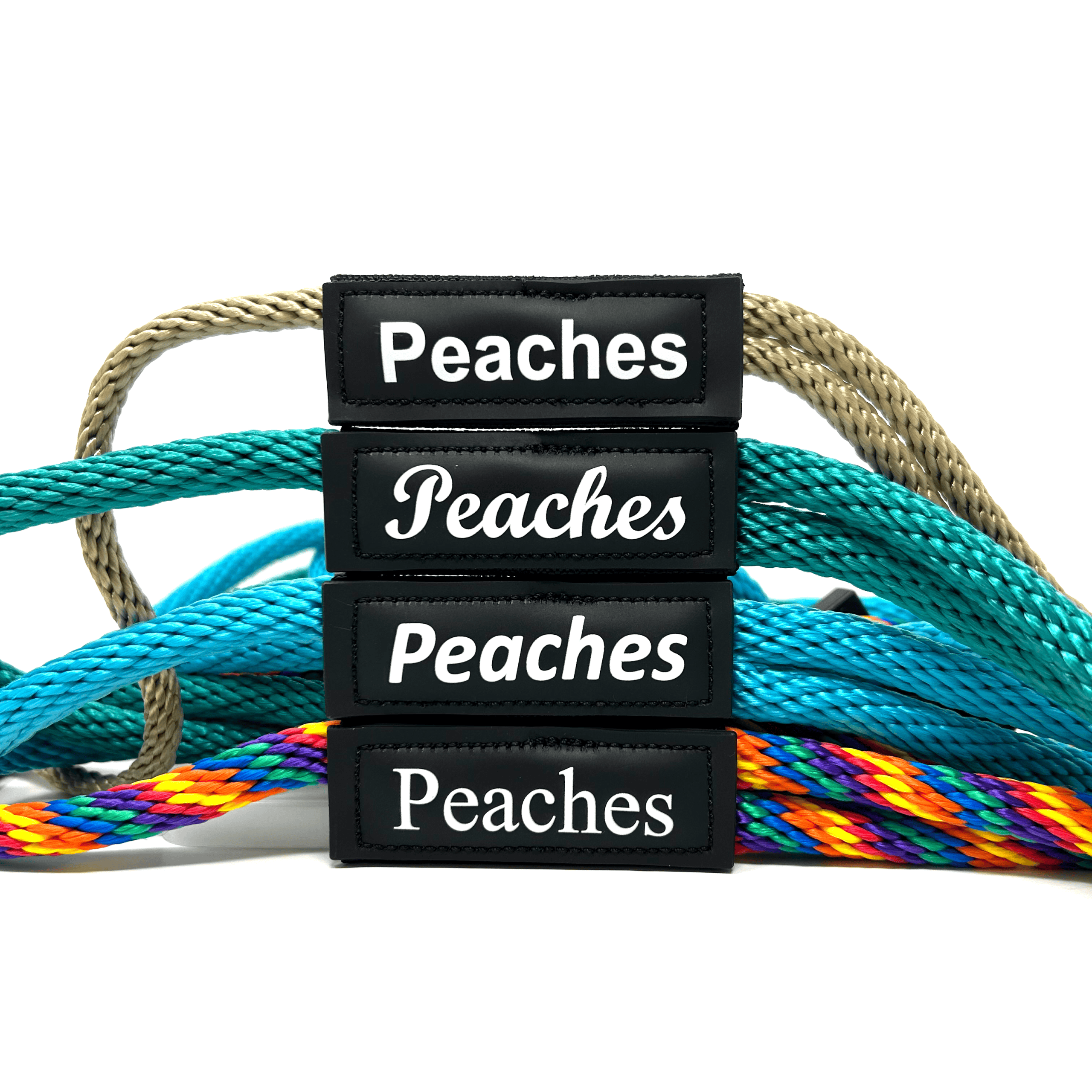 Thermal Patch Fonts Four black Peaches name patches stacked in front of ropes.