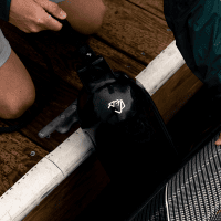 Mad Dog Products Inflatable Boat Fenders Inflatable boat fender with black surface and white logo on dock.